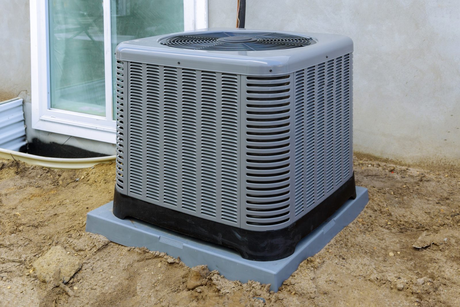 A newly replaced AC unit outside of a home